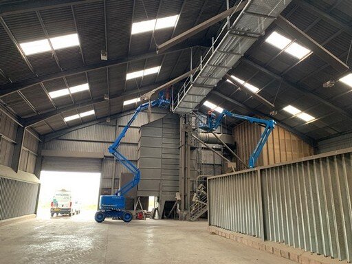Fitting new walkway in grain shed on farm.JPG